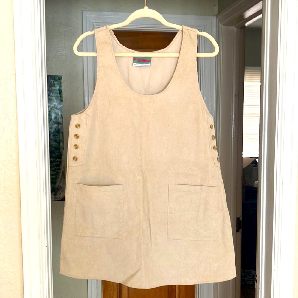 Tan corduroy dress from urban outfitters , has a wide fit , knee length